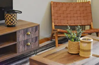 a living room with a chair and a wooden table at Vintage Apartment in Athens