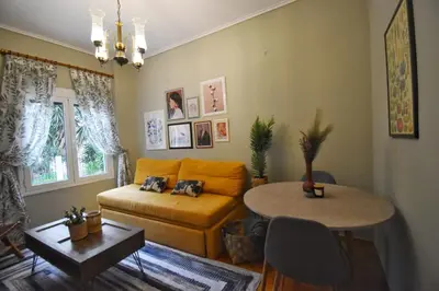 a living room with a couch and a table at Vintage Apartment in Athens