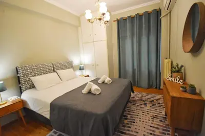 a bedroom with a bed with two towels on it at Vintage Apartment in Athens
