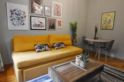 a living room with a couch and a table at Vintage Apartment in Athens