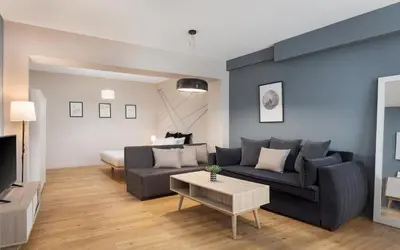 a living room with a couch and a table at Comfort Suite by Acropolis Cozy Suites in Athens