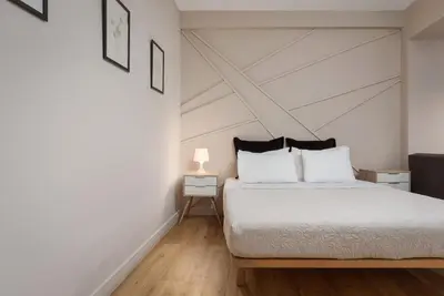 a bedroom with a white bed and a white ceiling at Comfort Suite by Acropolis Cozy Suites in Athens