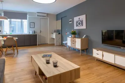 a living room with a coffee table and a television at Comfort Suite by Acropolis Cozy Suites in Athens