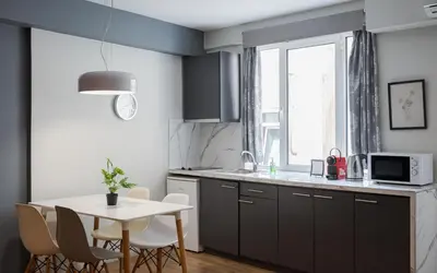 a kitchen with a table and a white table and chairs at Comfort Suite by Acropolis Cozy Suites in Athens