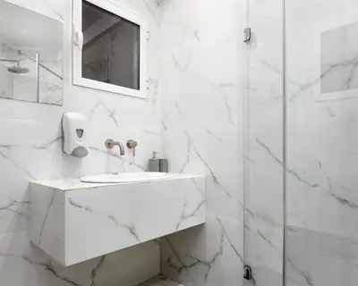 a white bathroom with a sink and a shower at Classic Suite by Acropolis Cozy Suites in Athens