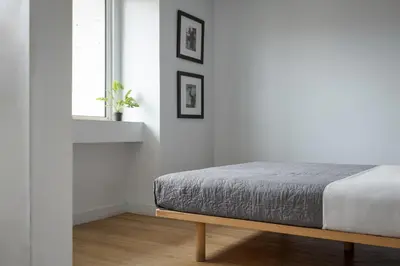 a white bedroom with a bed and a window at Classic Suite by Acropolis Cozy Suites in Athens