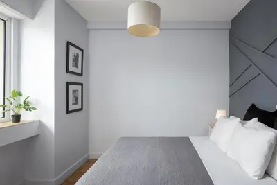 a bedroom with white walls and a bed with white pillows at Classic Suite by Acropolis Cozy Suites in Athens