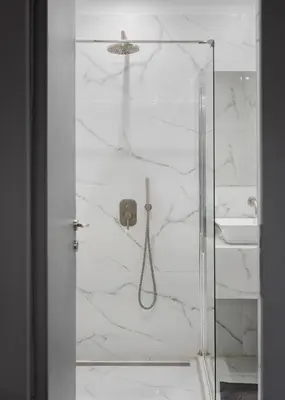 a bathroom with a shower with a glass door at Standard Suite by Acropolis Cozy Suites in Athens