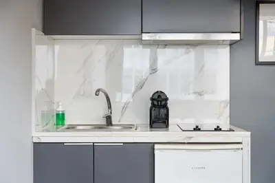 a white kitchen with a sink and aaucet at Standard Suite by Acropolis Cozy Suites in Athens