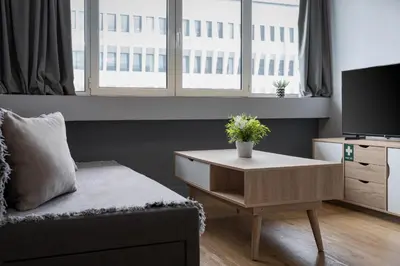 a living room with a couch and a table with a tv at Standard Suite by Acropolis Cozy Suites in Athens