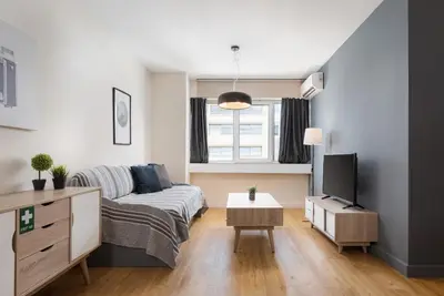 a living room with a bed and a tv at Deluxe Suite by Acropolis Cozy Suites in Athens