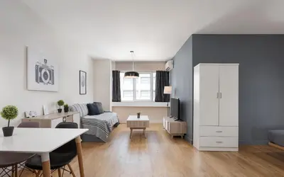 a living room with a bed and a table at Deluxe Suite by Acropolis Cozy Suites in Athens