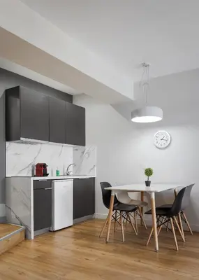 a kitchen and dining room with a table and chairs at Deluxe Suite by Acropolis Cozy Suites in Athens