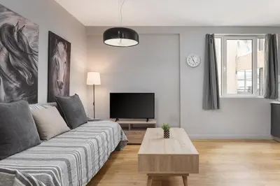 a living room with a couch and a tv at Superior Suite by Acropolis Cozy Suites in Athens