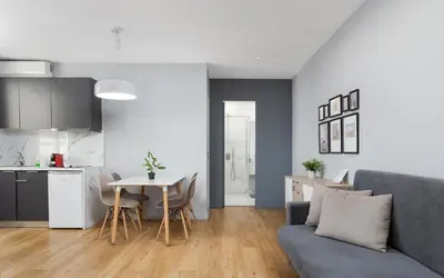 a living room and kitchen with a couch and a table at Superior Suite by Acropolis Cozy Suites in Athens