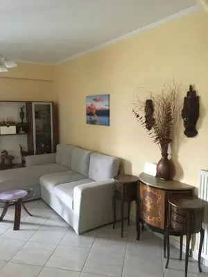 a living room with a couch and a table at SECOND FLOOR Best stay in Athens