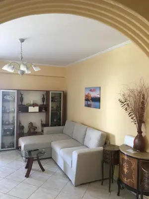 a living room with a couch and a table at SECOND FLOOR Best stay in Athens