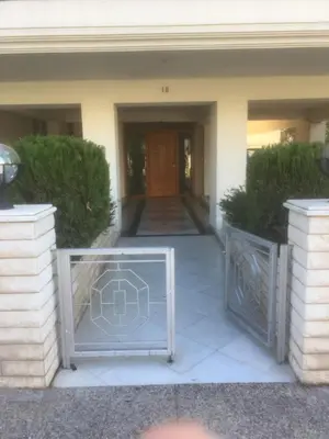 a gate in front of a building with a door at SECOND FLOOR Best stay in Athens