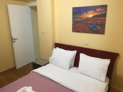 a bed with white sheets and pillows in a room at SECOND FLOOR Best stay in Athens