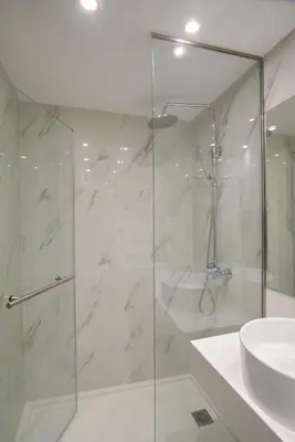 a bathroom with a glass shower and a sink at International Atene hotel in Athens