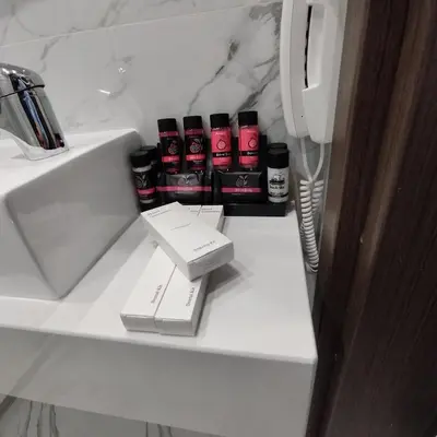 a bathroom counter with a sink and a phone at International Atene hotel in Athens