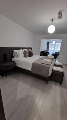 a bedroom with a large bed and a chair at International Atene hotel in Athens