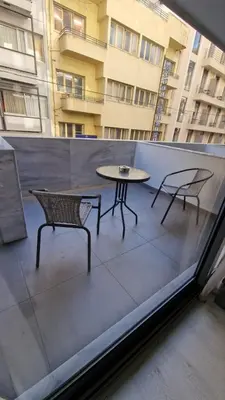 a patio with two chairs and a table on a balcony at International Atene hotel in Athens