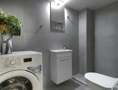 a bathroom with a washing machine and a sink at New Hidden Gem, A Studio at a Super Prime Location in Athens