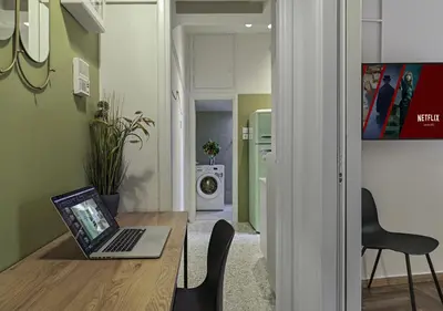 a laptop computer sitting on a wooden table in a room at New Hidden Gem, A Studio at a Super Prime Location in Athens