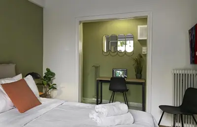 a bedroom with a bed and a desk and a mirror at New Hidden Gem, A Studio at a Super Prime Location in Athens