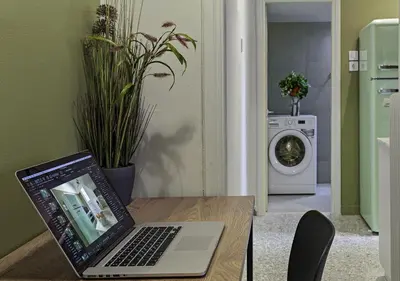 a laptop computer sitting on a table in a kitchen at New Hidden Gem, A Studio at a Super Prime Location in Athens