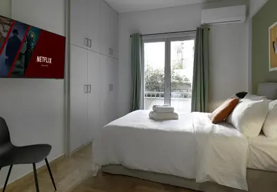 a bedroom with a white bed and a window at New Hidden Gem, A Studio at a Super Prime Location in Athens