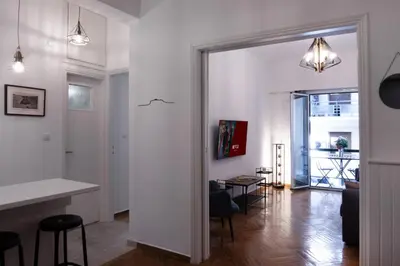 a living room with a door leading to a dining room at Rare 1BR APT, next to the new Goulandris Museum in Athens