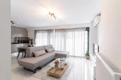 a living room with a couch and a table at Niarchos Panorama Maisonette in Athens