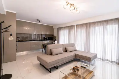 a living room with a couch and a table at Niarchos Panorama Maisonette in Athens