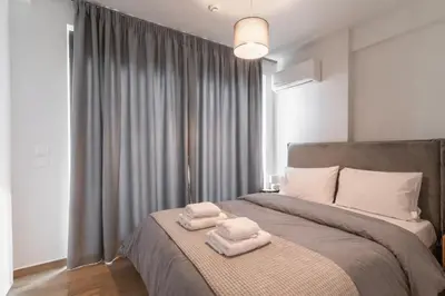 a bedroom with a bed with two towels on it at Niarchos Panorama Maisonette in Athens