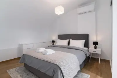 a bedroom with a bed with two towels on it at Niarchos Panorama Maisonette in Athens