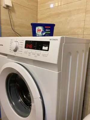 a washing machine with a timer on top of it at Traveller's Choice in Athens