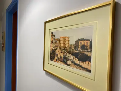 a framed picture of a city on a wall at Traveller's Choice in Athens