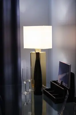 a lamp and two wine glasses on a table at K23 Color Suites in Athens