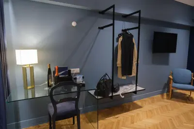 a room with a glass table and a chair at K23 Color Suites in Athens