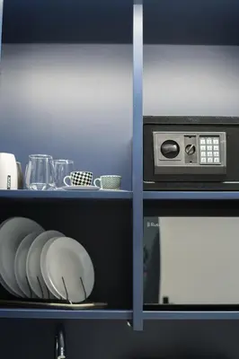 a shelf with a microwave and dishes on it at K23 Color Suites in Athens