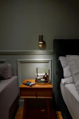 a nightstand with a phone on it next to a bed at K23 Color Suites in Athens