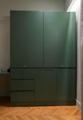 a kitchen with green cabinets and a wooden floor at K23 Color Suites in Athens