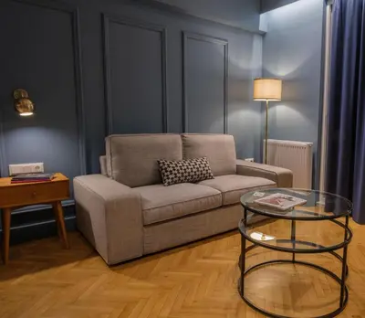 a living room with a couch and a glass table at K23 Color Suites in Athens