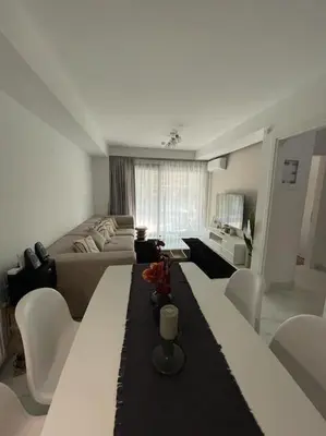 a living room with a long table and a couch at Niarchos apartment III in Athens