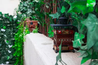 a toy train on a path with plants at Lysandros Apartments in Athens, near the METRO in Athens