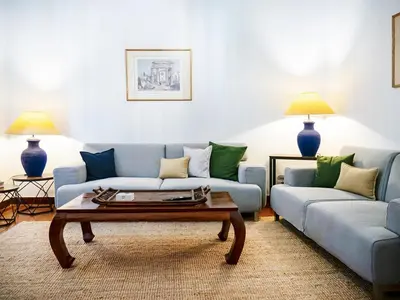 a living room with two blue couches and a coffee table at The Arcade in Athens