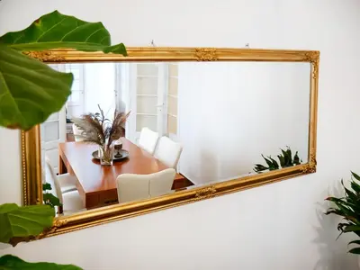 a mirror on a wall with a table and a dining room at The Arcade in Athens
