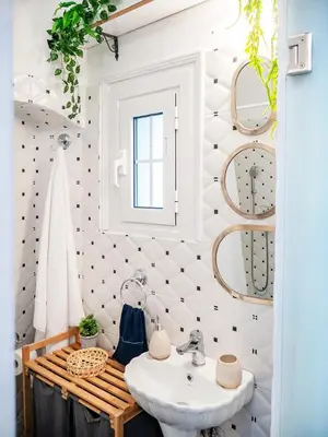 a bathroom with a white sink and a bench at The Arcade in Athens